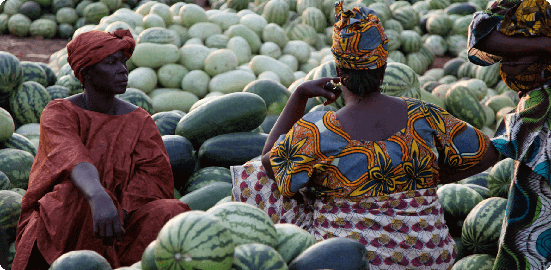 African women among heaps of watermelons