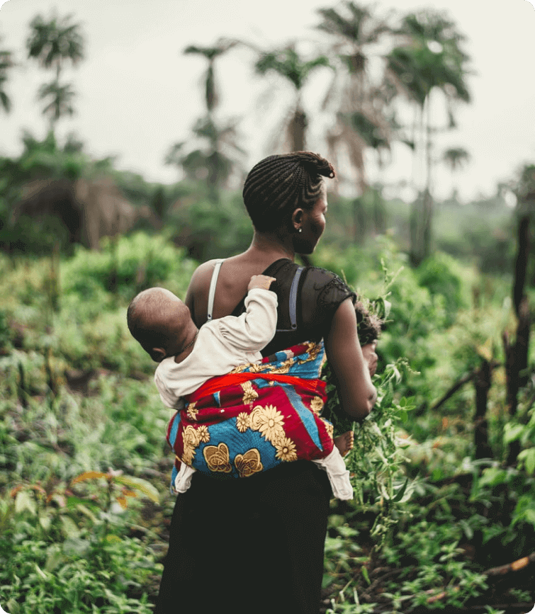 African farmer with baby on her back