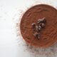 Cocoa powder with pieces o raw chocolate on top